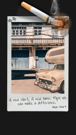 A poloroid photo of a camper van in front of an auto shop, being burned by a cigarette